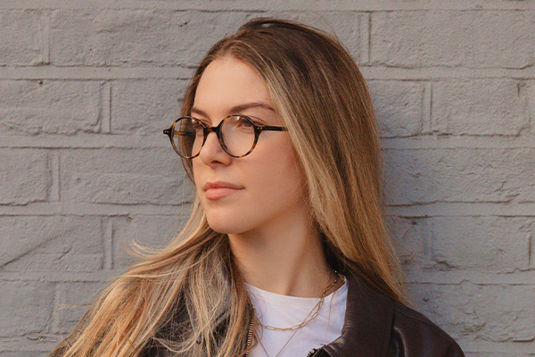 Woman wearing glasses looking into the distance