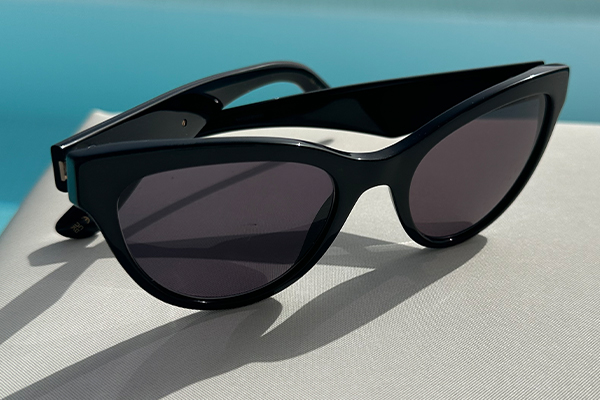 Angular pair of sunglasses by a swimming pool